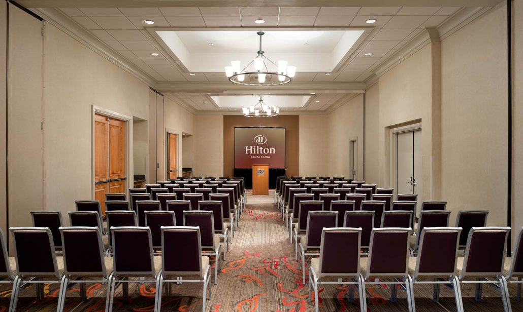 Theater-style meeting room setup at Hilton Santa Clara with AV support, part of Santa Clara catering for events and business packages.